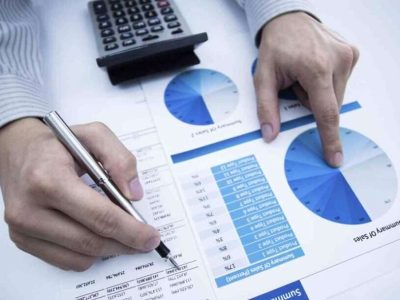 man hand with pen and business report. Accounting